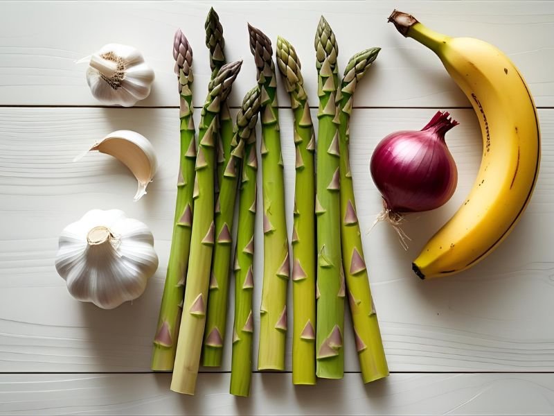 A collection of prebiotic-rich foods, including asparagus, garlic, and onions, which are essential for restoring the gut microbiome.